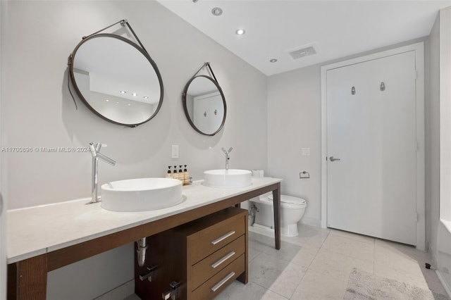 bathroom featuring tile patterned flooring, vanity, and toilet