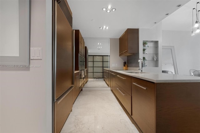 kitchen with kitchen peninsula, decorative backsplash, stainless steel appliances, and sink