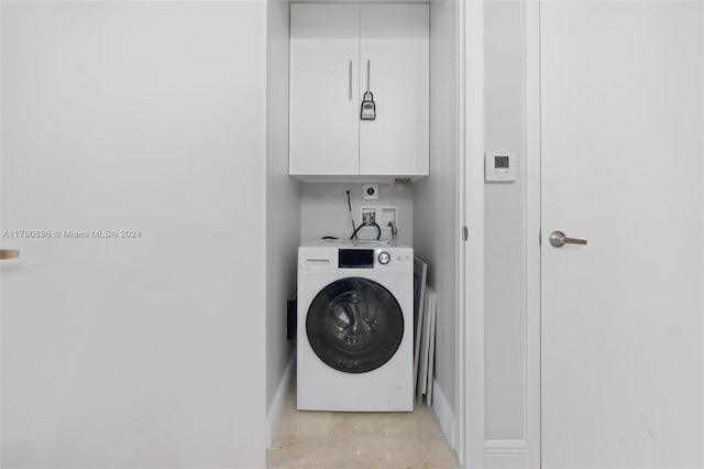 laundry area with cabinets and washer / dryer