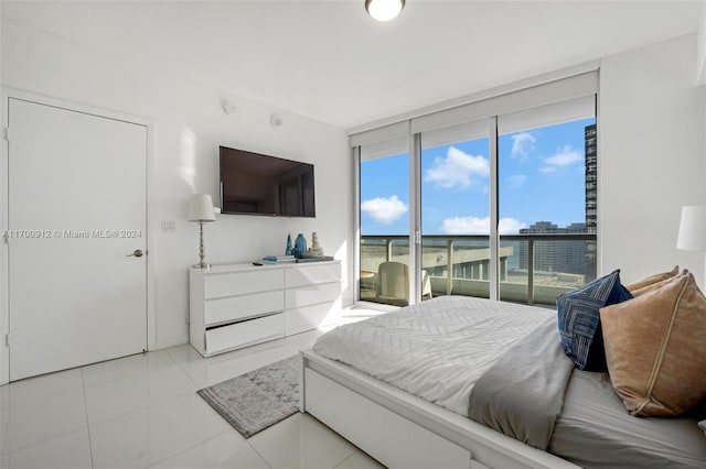 bedroom featuring access to exterior and light tile patterned floors