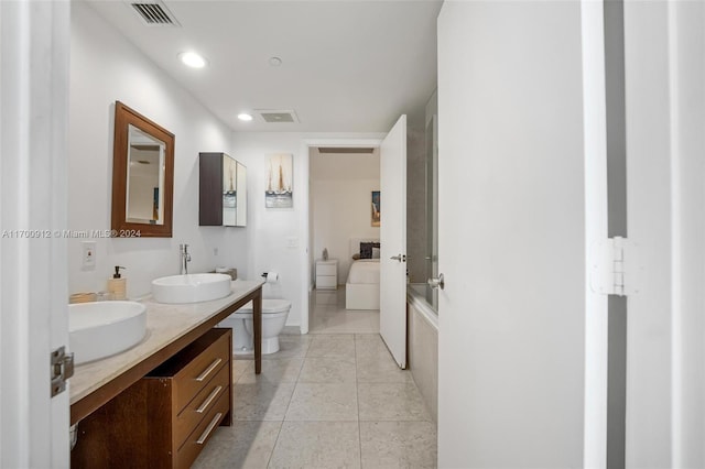 bathroom with tile patterned floors, vanity, and toilet