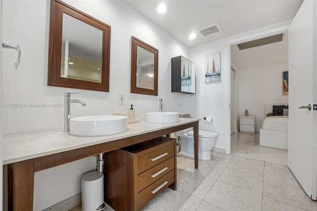 bathroom with tile patterned floors, vanity, and toilet