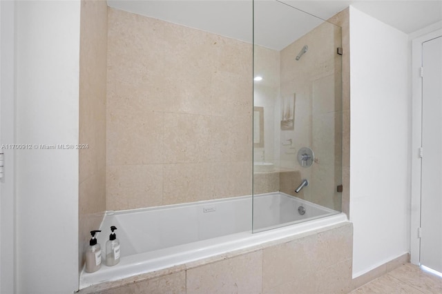 bathroom with tile patterned flooring and tiled shower / bath