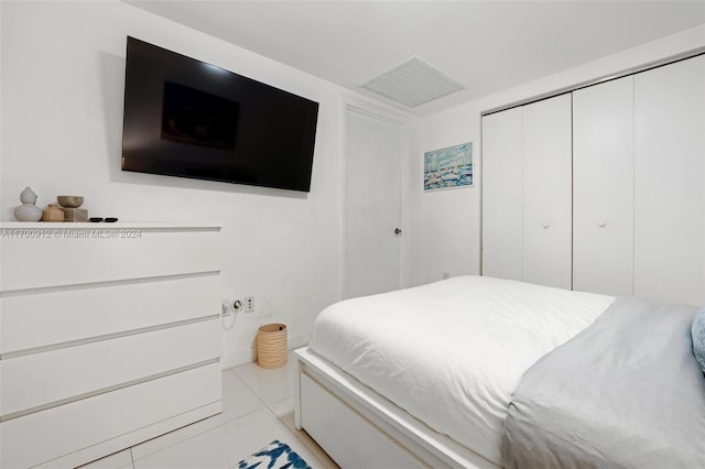 bedroom featuring light tile patterned floors and a closet