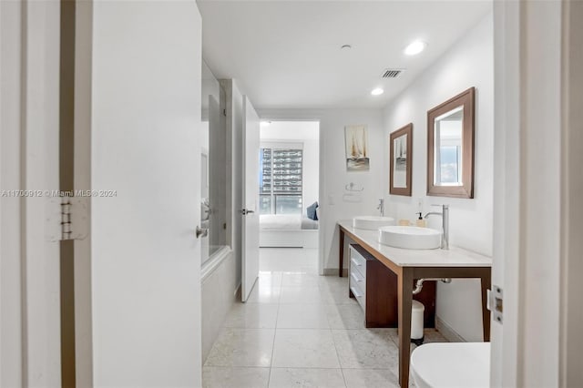 bathroom with tile patterned flooring, vanity, and toilet