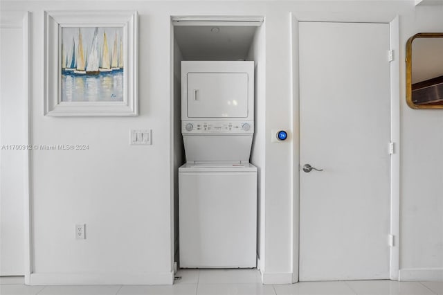 washroom featuring light tile patterned floors and stacked washer / dryer