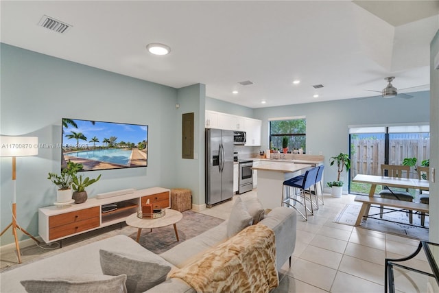 living room with recessed lighting, visible vents, baseboards, and light tile patterned flooring