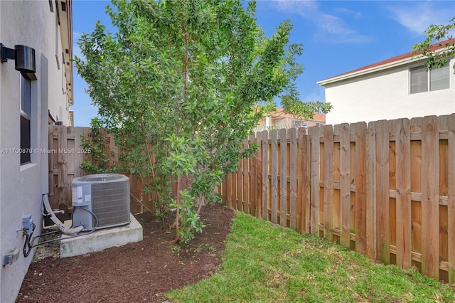 887 NE 211th St Unit 887, Miami, FL 33179 - view of yard with central AC and a fenced backyard