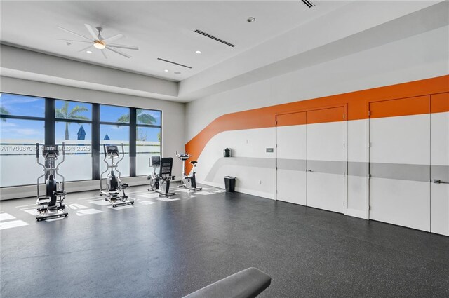 workout area featuring ceiling fan and a towering ceiling