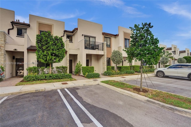 887 NE 211th St Unit 887, Miami, FL 33179 - view of building exterior with uncovered parking and a residential view