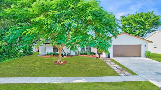 obstructed view of property with a garage and a front yard