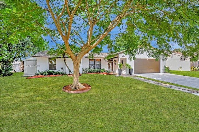 ranch-style home with a garage and a front lawn