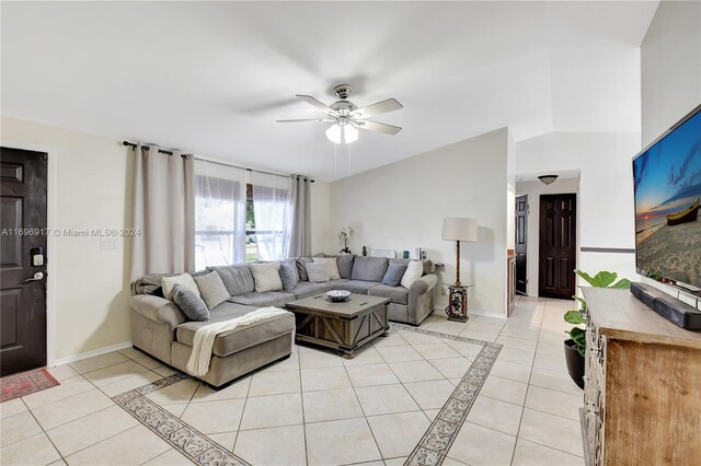 living room with ceiling fan and light tile patterned floors