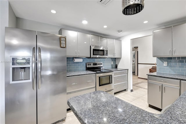 kitchen featuring gray cabinetry, backsplash, light tile patterned floors, and stainless steel appliances