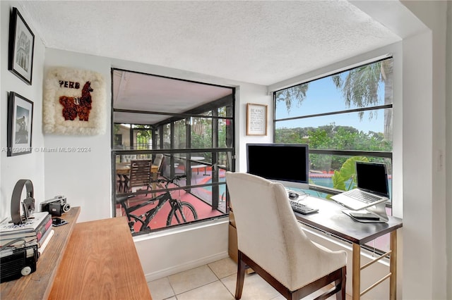 home office featuring light tile patterned floors and a textured ceiling