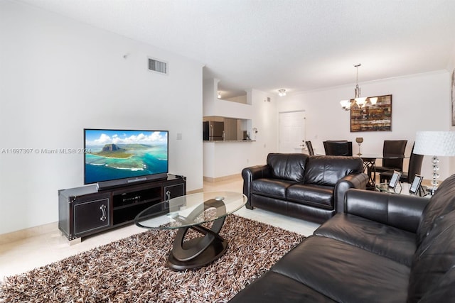 tiled living room featuring a notable chandelier and a textured ceiling