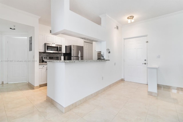 kitchen featuring white cabinets, crown molding, tasteful backsplash, kitchen peninsula, and stainless steel appliances