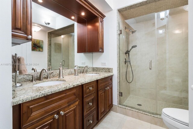 bathroom featuring tile patterned flooring, vanity, toilet, and walk in shower