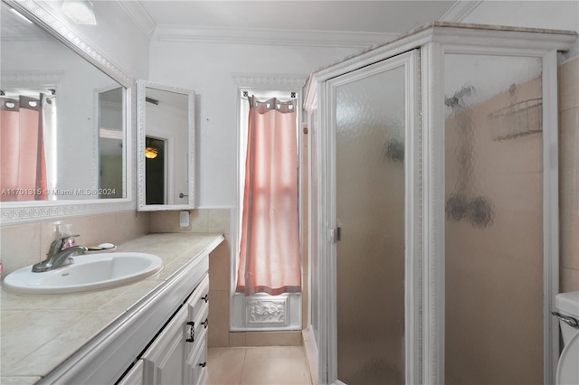 bathroom with tasteful backsplash, tile patterned floors, a shower with door, vanity, and ornamental molding