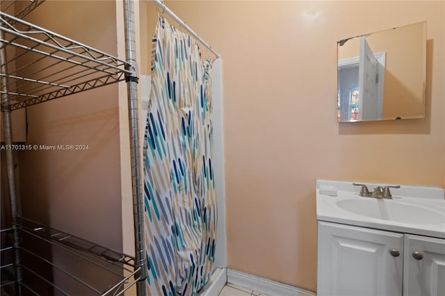 bathroom featuring tile patterned flooring and vanity