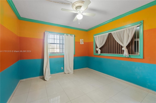 spare room with ceiling fan and ornamental molding