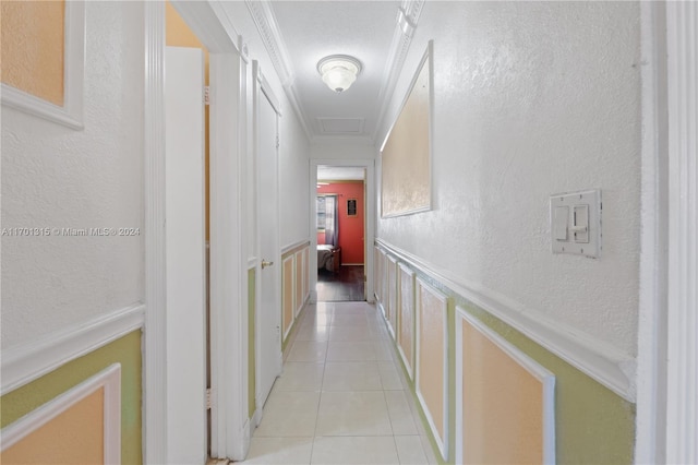 corridor with light tile patterned floors and ornamental molding