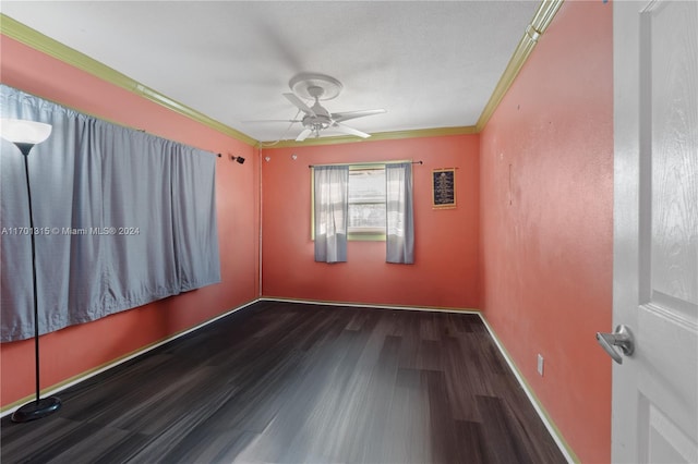 unfurnished room featuring crown molding, dark hardwood / wood-style flooring, and ceiling fan