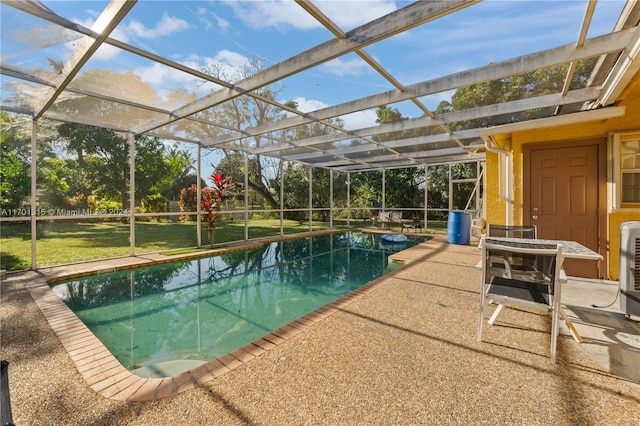 view of pool with a lanai, a patio area, and a yard