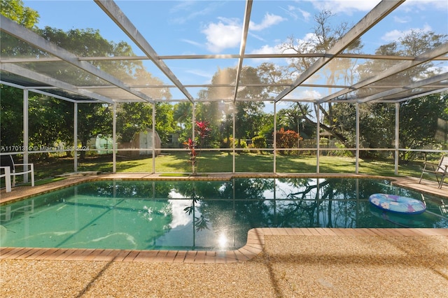 view of pool featuring glass enclosure and a storage unit