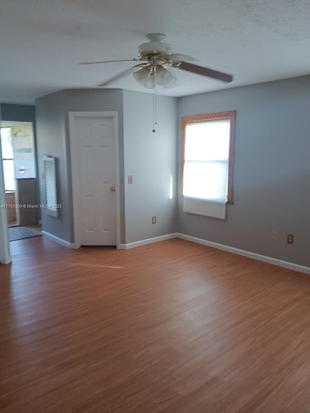 spare room with hardwood / wood-style flooring and ceiling fan