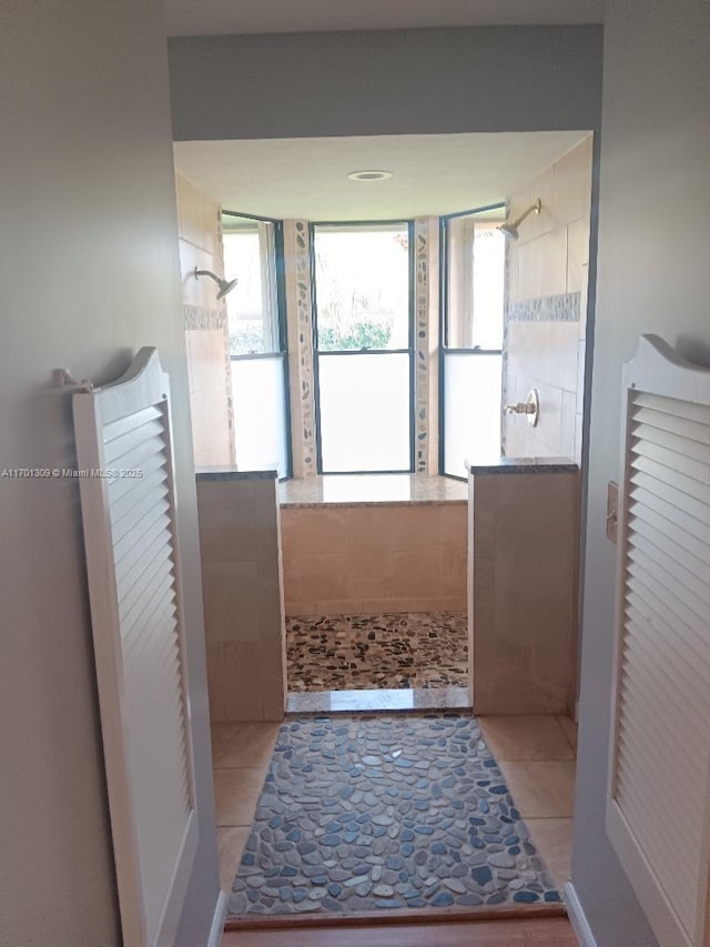 bathroom featuring a shower and tile patterned flooring