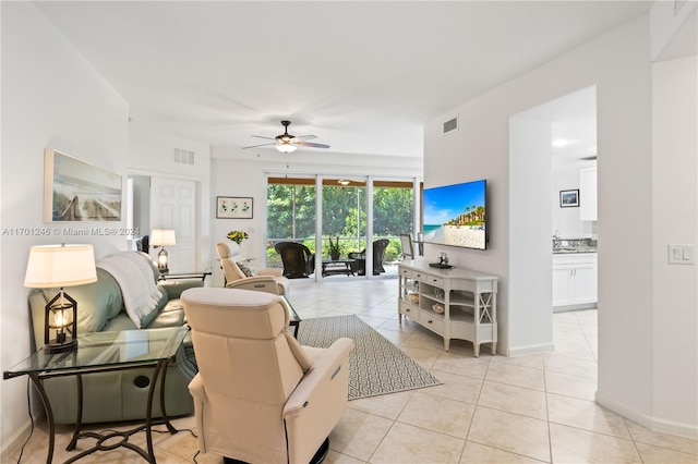 tiled living room with ceiling fan