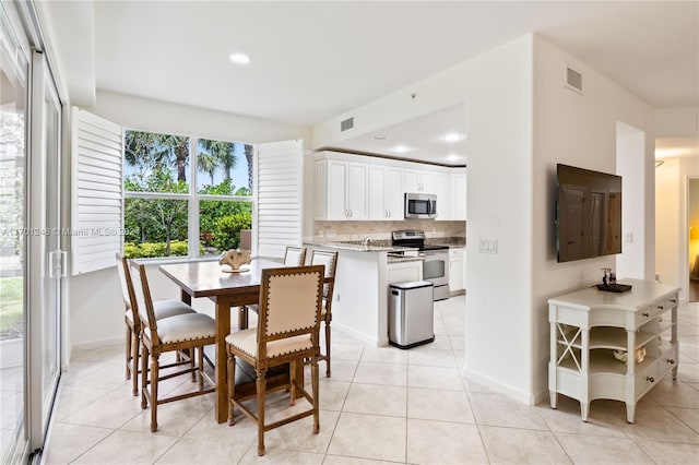 dining area featuring light tile patterned floors