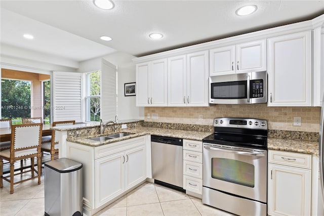 kitchen with white cabinetry, sink, and appliances with stainless steel finishes