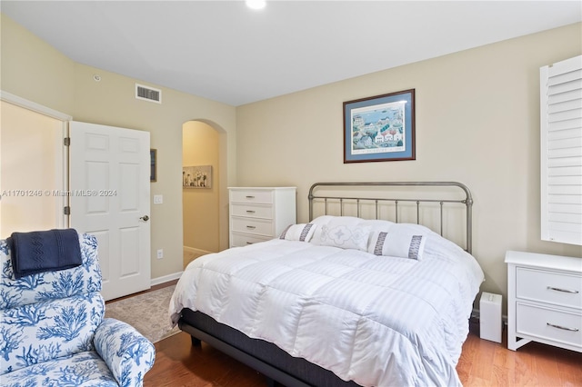 bedroom with hardwood / wood-style floors