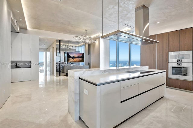 kitchen with white cabinetry, an inviting chandelier, double oven, black electric cooktop, and island range hood