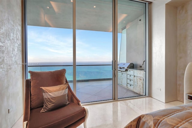 sitting room with expansive windows and a water view