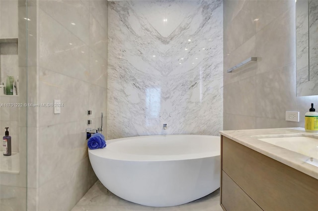 bathroom featuring vanity, tile walls, and a tub