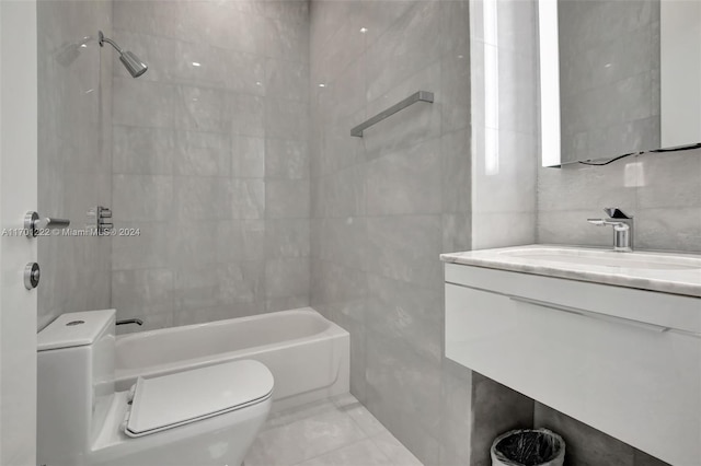 full bathroom featuring vanity, tiled shower / bath combo, tile walls, and toilet