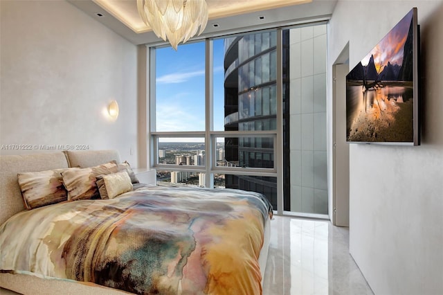 bedroom with a chandelier and expansive windows