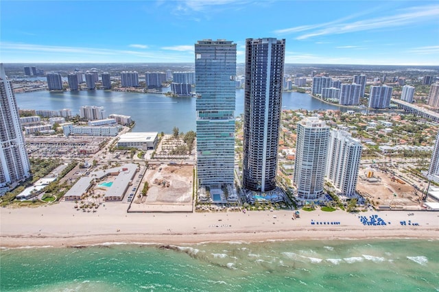 drone / aerial view featuring a water view and a view of the beach