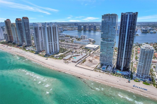 bird's eye view featuring a water view and a view of the beach