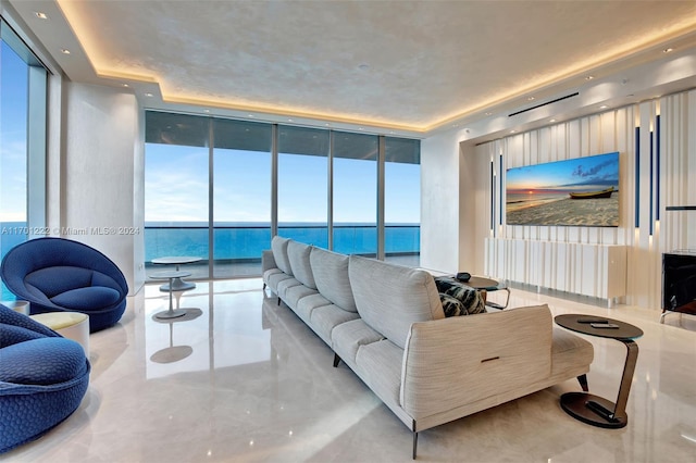 living room with floor to ceiling windows and a tray ceiling