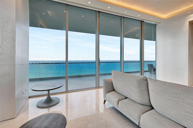 living room with floor to ceiling windows and a water view