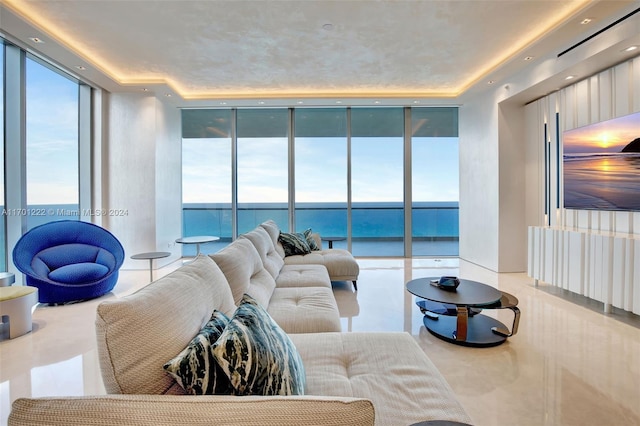 living room featuring a water view and expansive windows