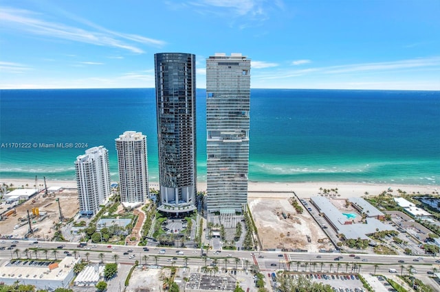 drone / aerial view featuring a beach view and a water view