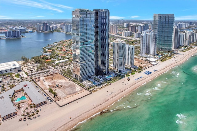 aerial view with a water view and a beach view