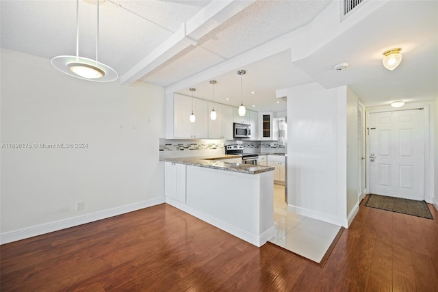 kitchen featuring white cabinets, pendant lighting, kitchen peninsula, and light hardwood / wood-style flooring