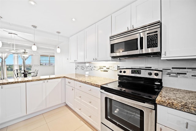 kitchen featuring pendant lighting, stainless steel appliances, white cabinetry, and tasteful backsplash