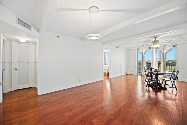 dining space featuring beamed ceiling, a textured ceiling, hardwood / wood-style flooring, and ceiling fan